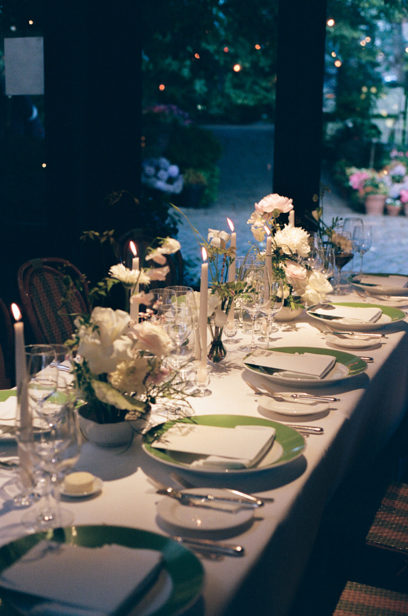 Intimate reception dinner with candlelight and floral arrangements