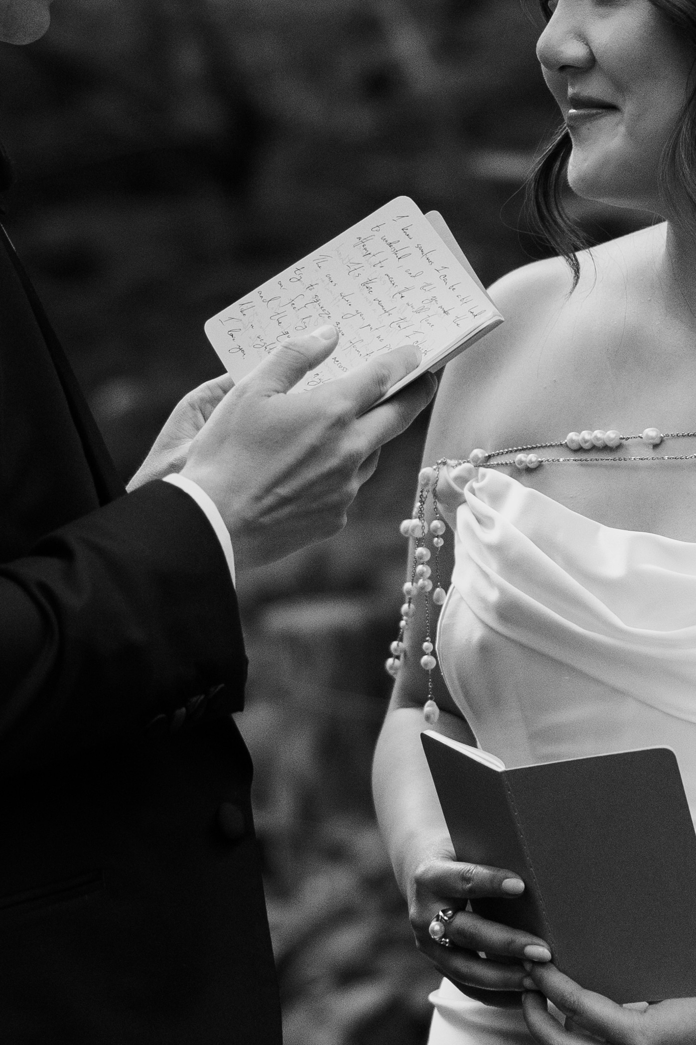 Couple exchanging vows as sunlight breaks through clouds