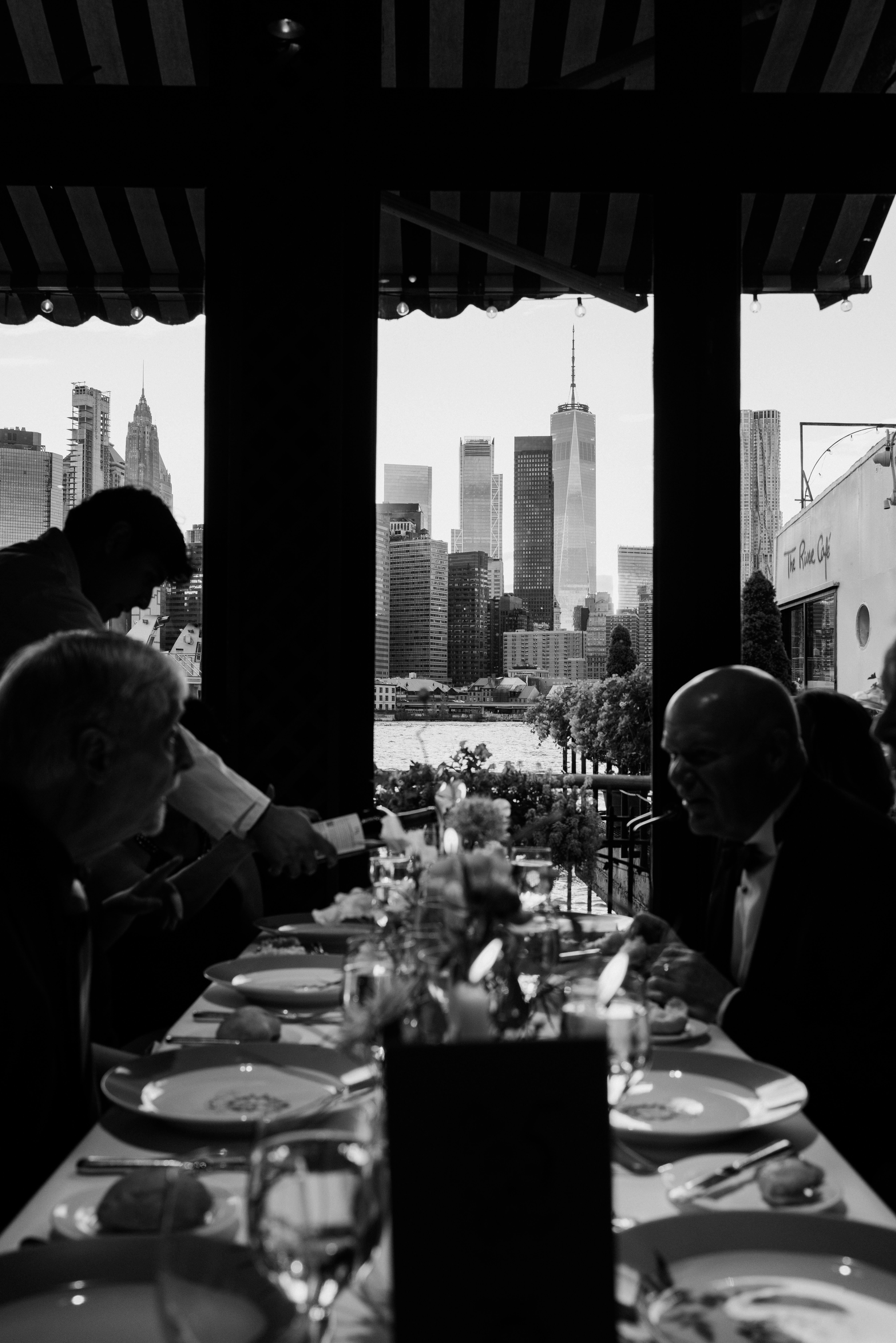 Intimate reception dinner with candlelight and floral arrangements overlooking Manhattan 