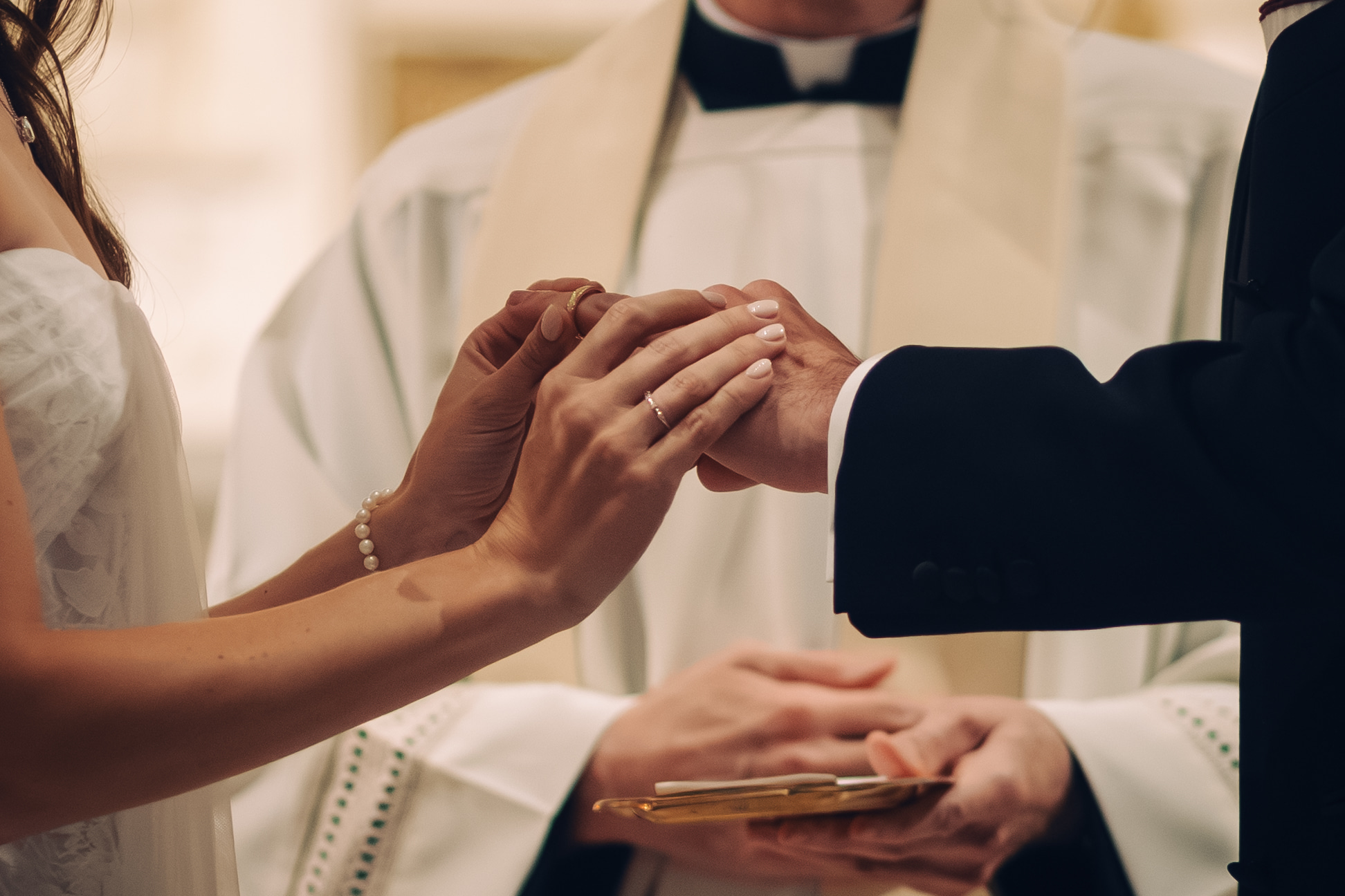 detail photo of couple exchanging rings during the ceremony
