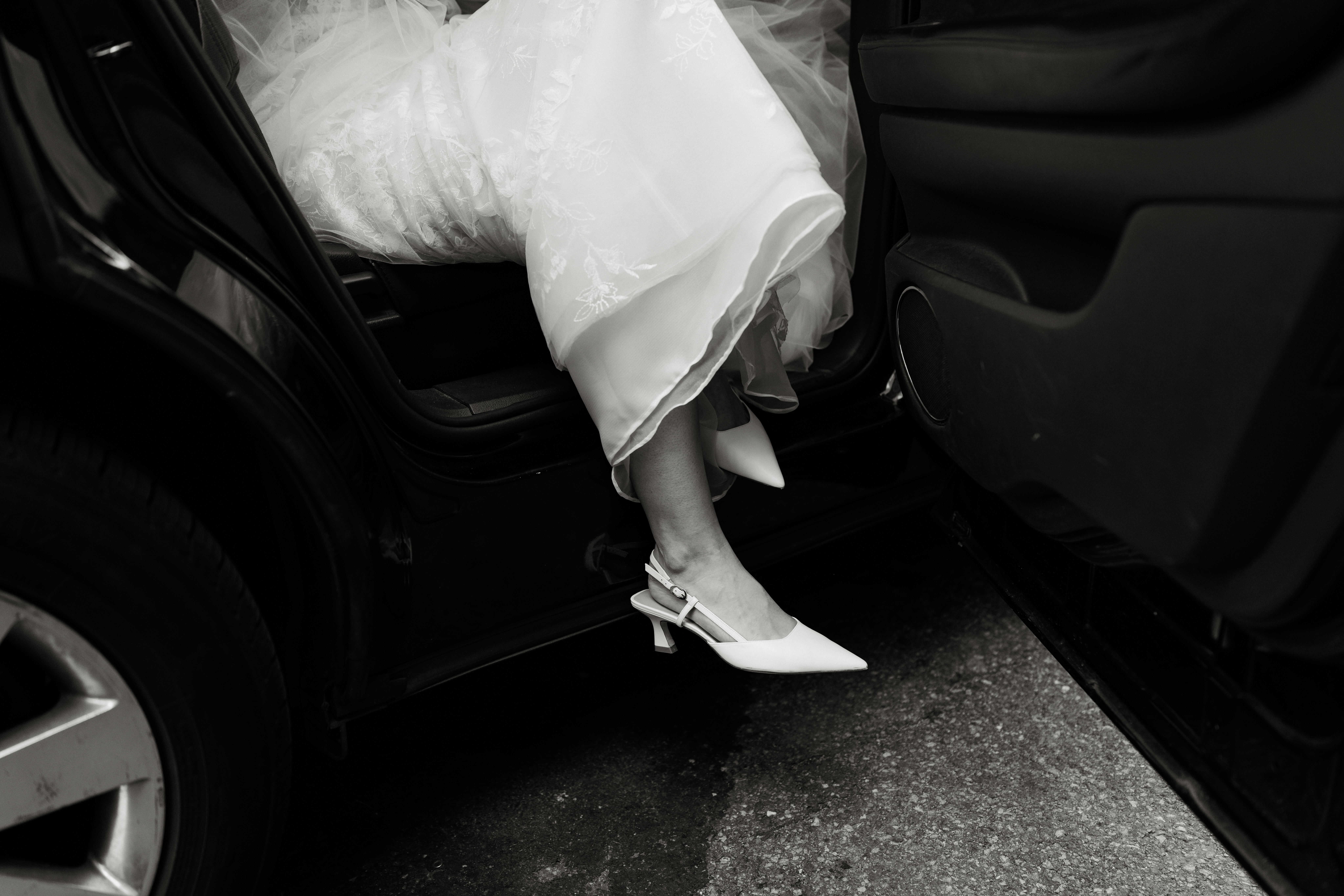 Bride stepping out of limousine in an editorial-style opening moment