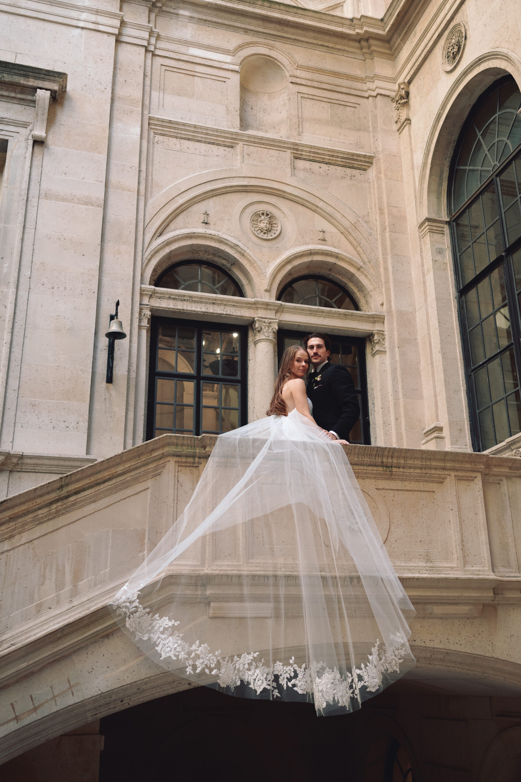 bride and groom on the steps of Burden Kahn Mansion