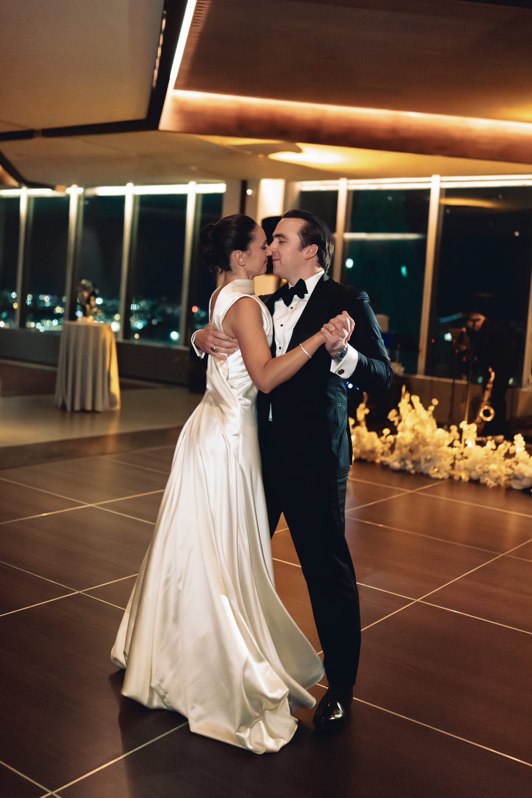 Candlelit reception space at Manhatta with skyline glowing at night