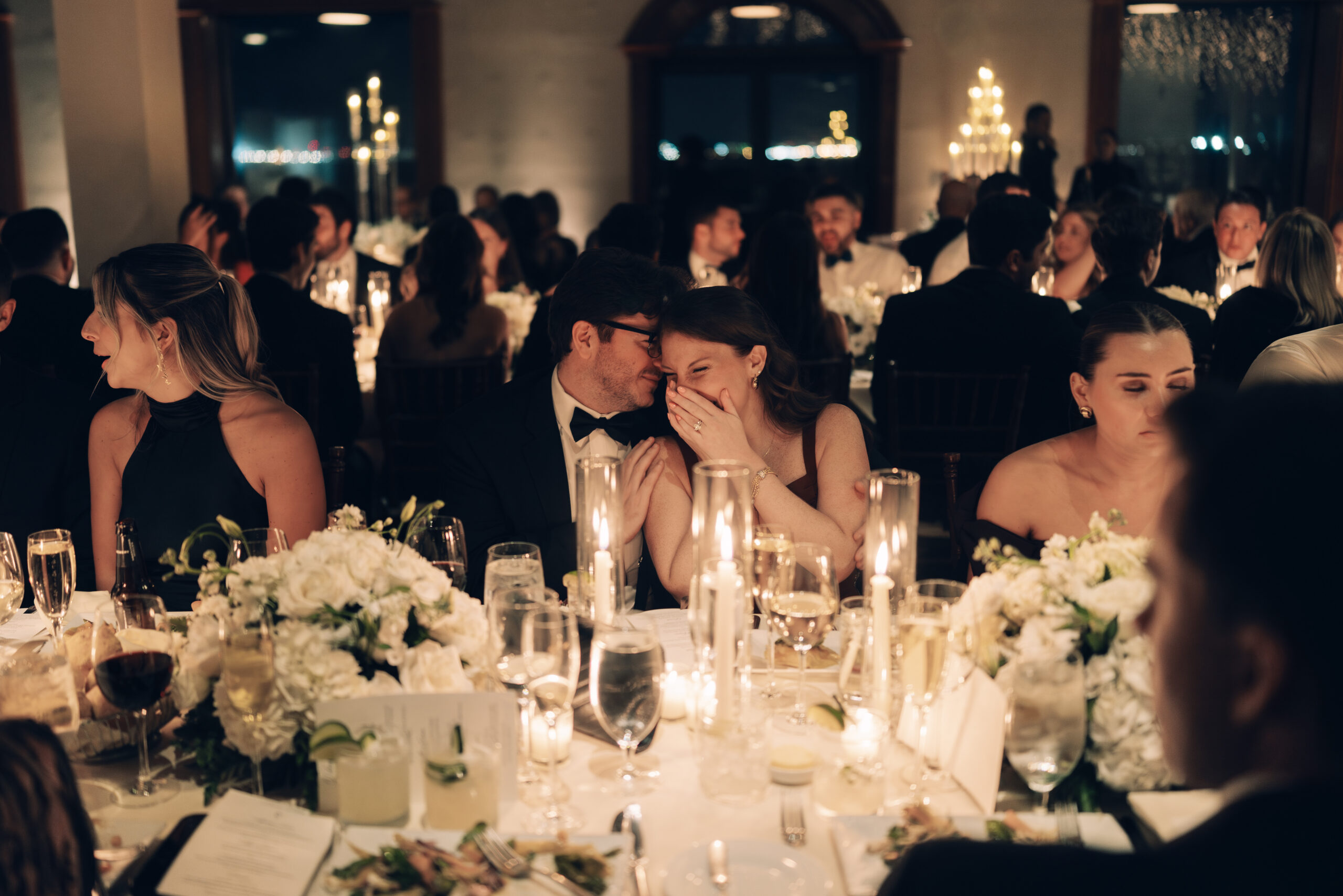 Candlelit reception tables glowing with romantic ambiance and candid guest moments