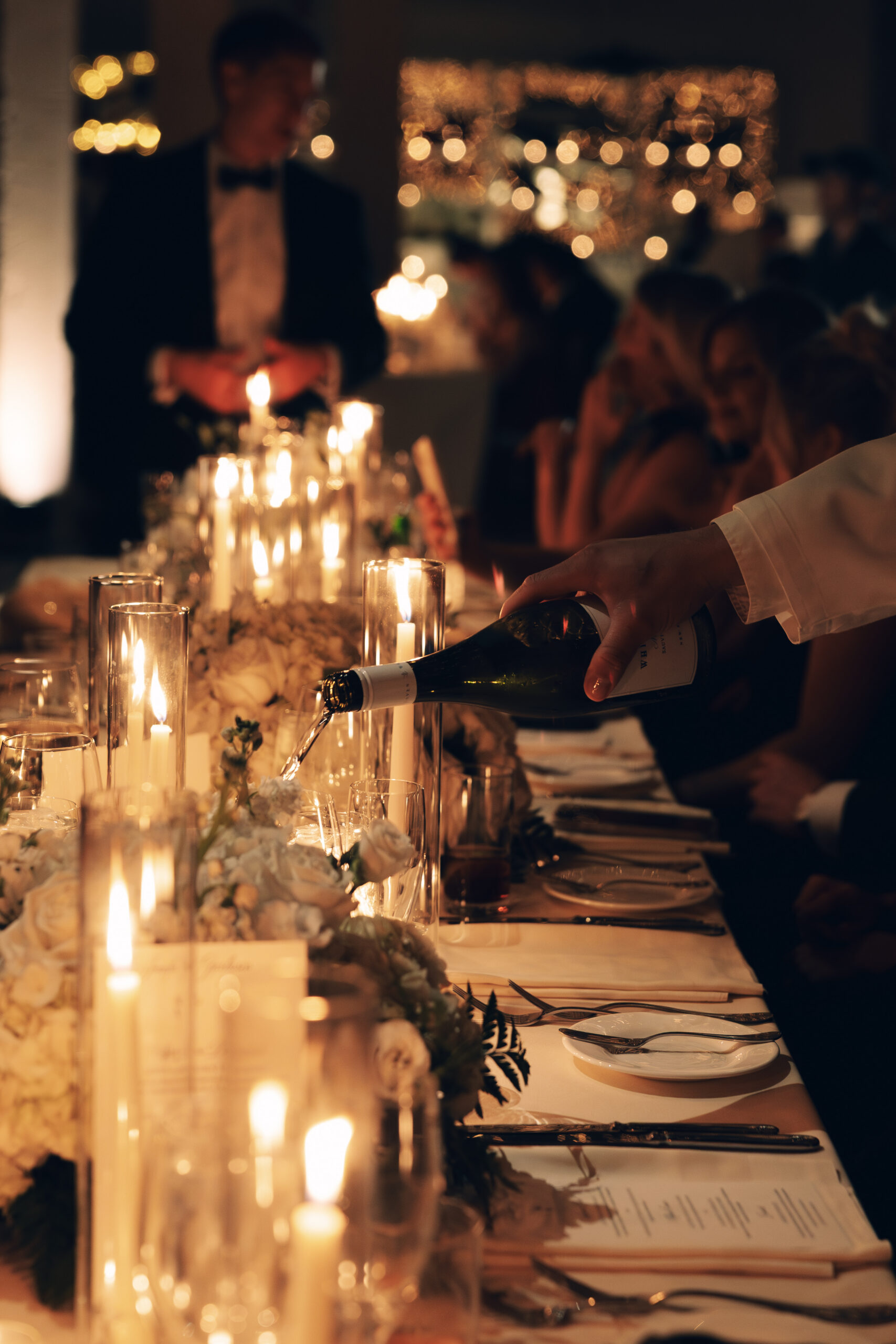 Candlelit reception tables glowing with romantic ambiance