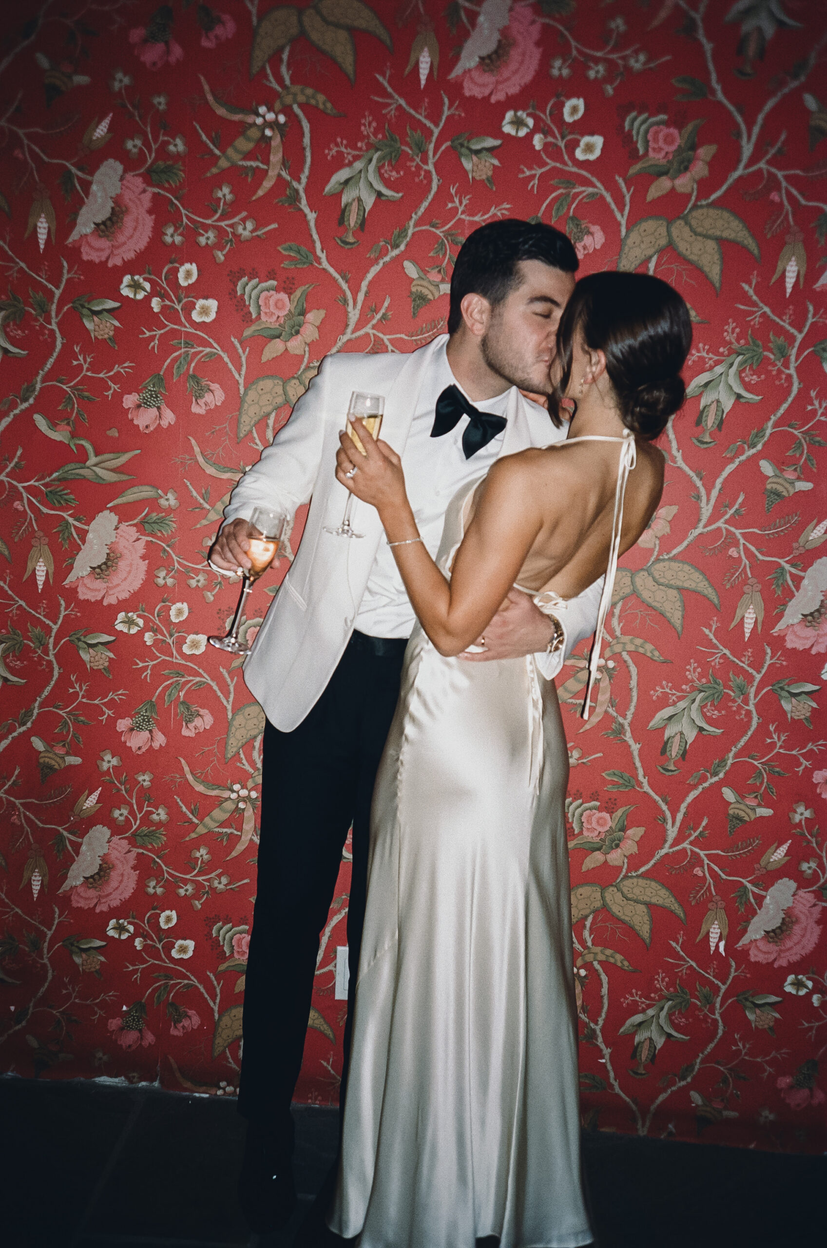 late night bride and groom photograph with a red wall
