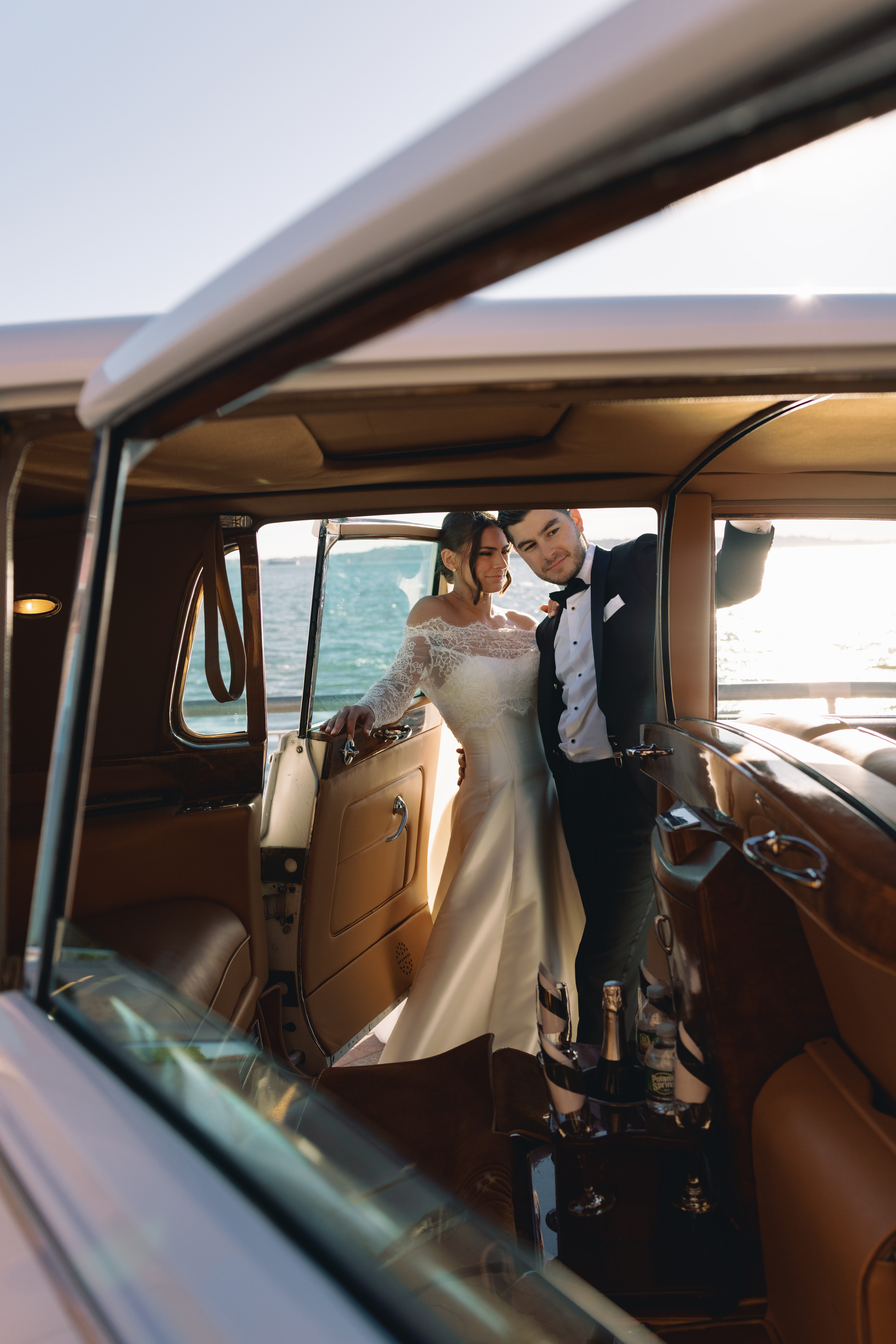 Emotional first look overlooking New York Harbor, non-face composition focused on hands and posture