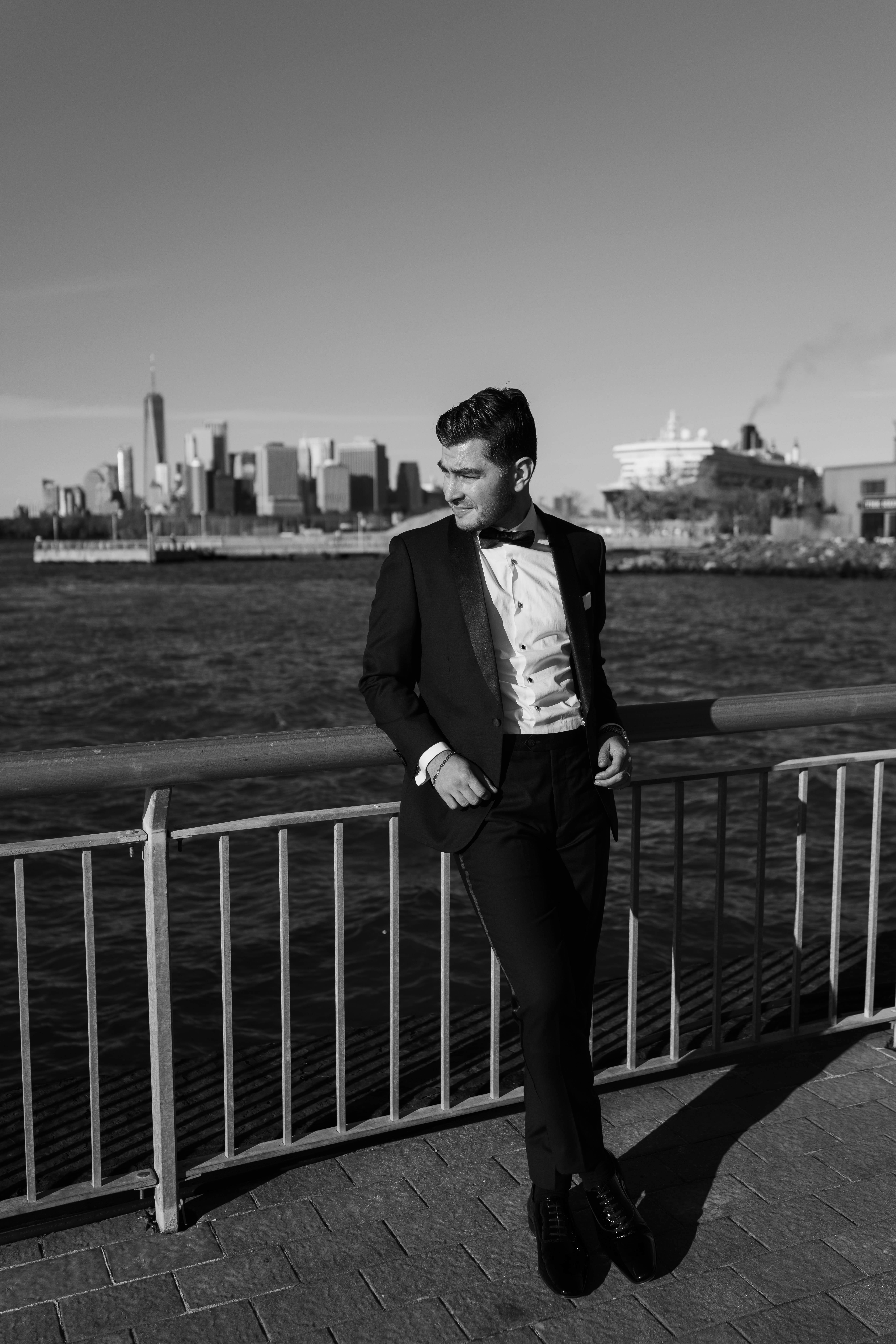 Emotional first look overlooking New York Harbor, non-face composition focused on hands and posture