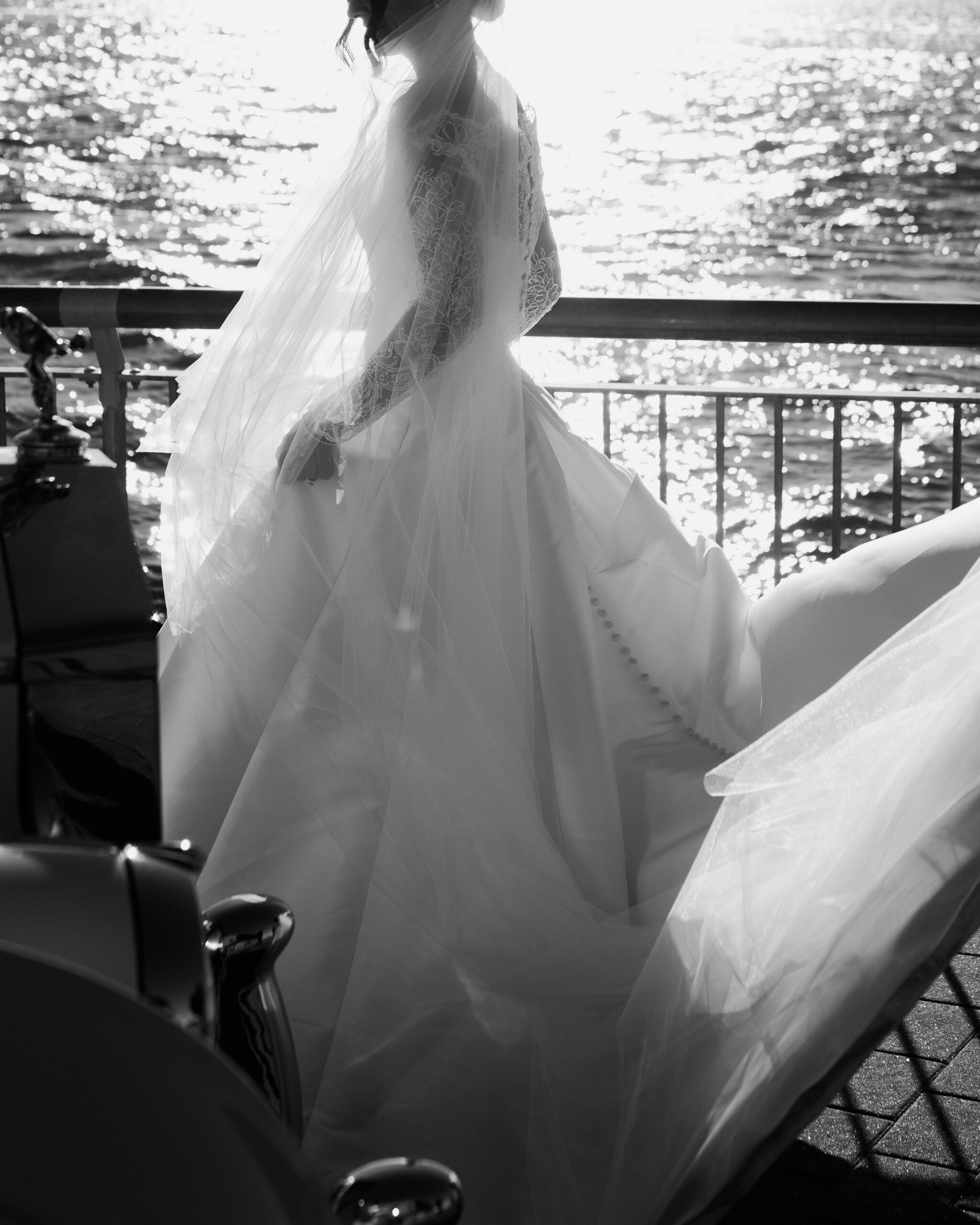 Emotional first look overlooking New York Harbor, non-face composition focused on hands and posture