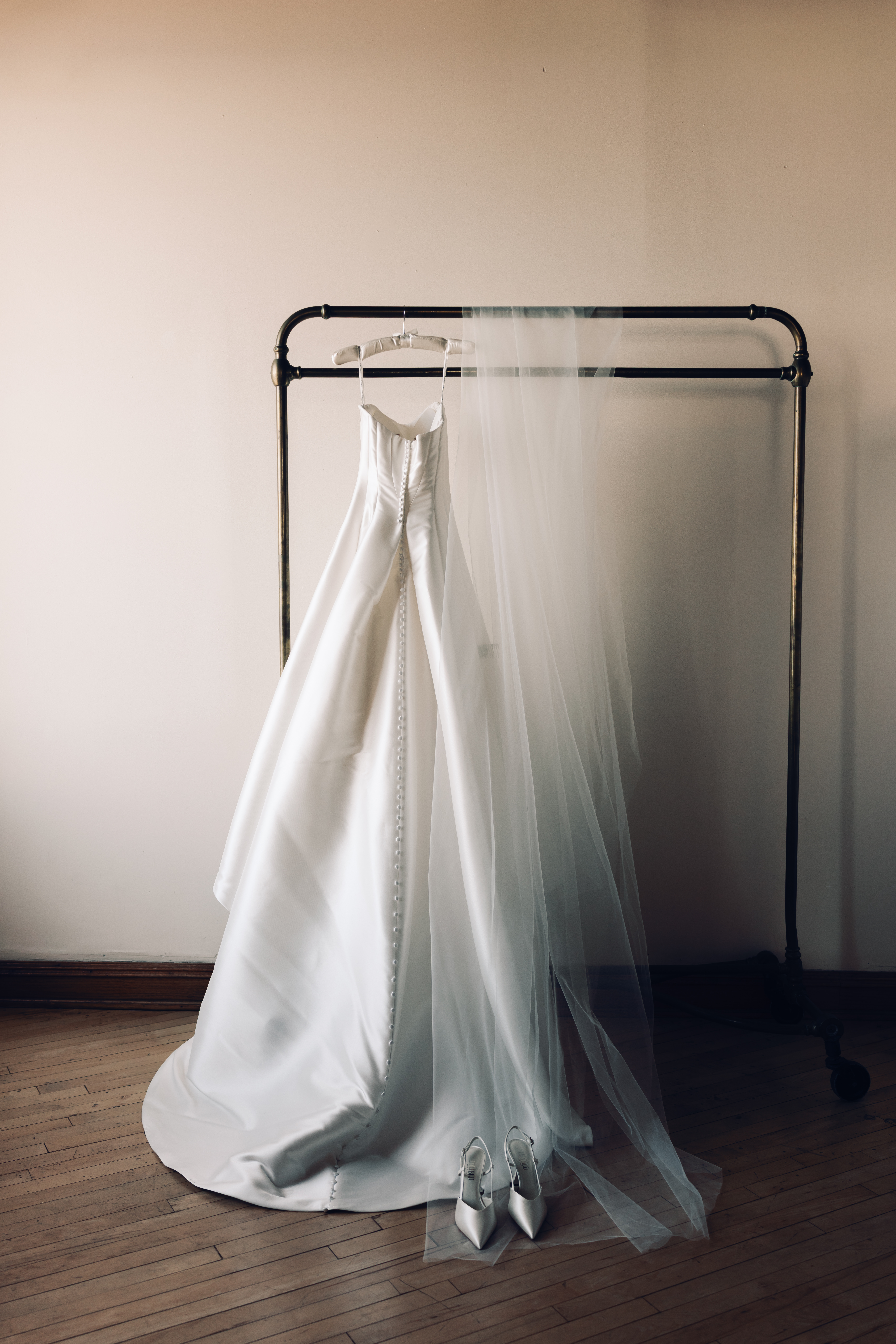 Bride’s gown from Park Avenue Bridals hanging in natural window light