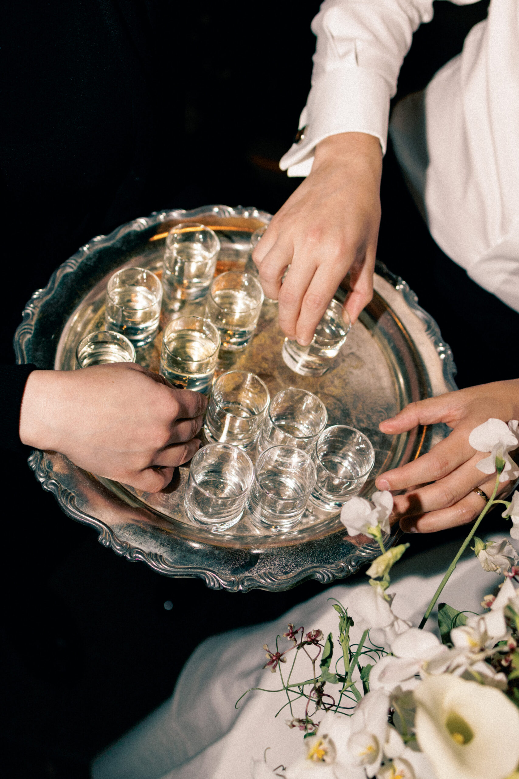 Guests raising sake glasses in celebration