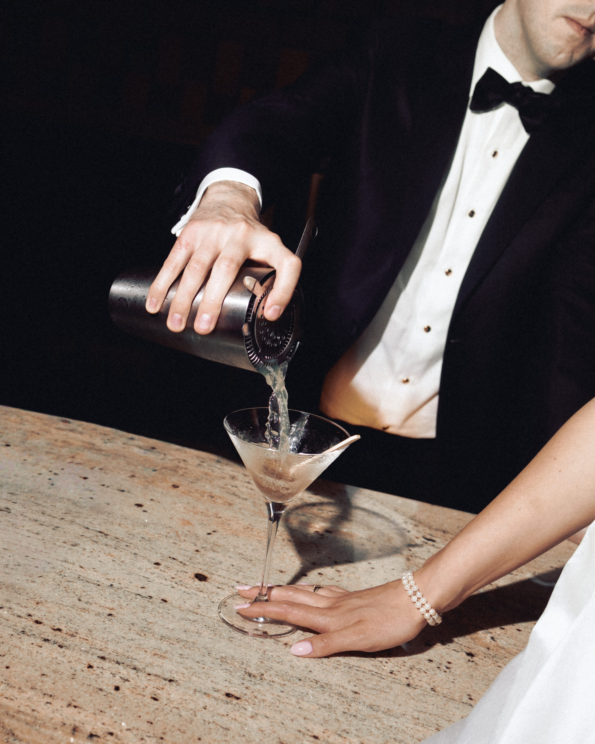 Editorial portraits behind a mahogany bar at a Modern Gatsby style wedding in New York.