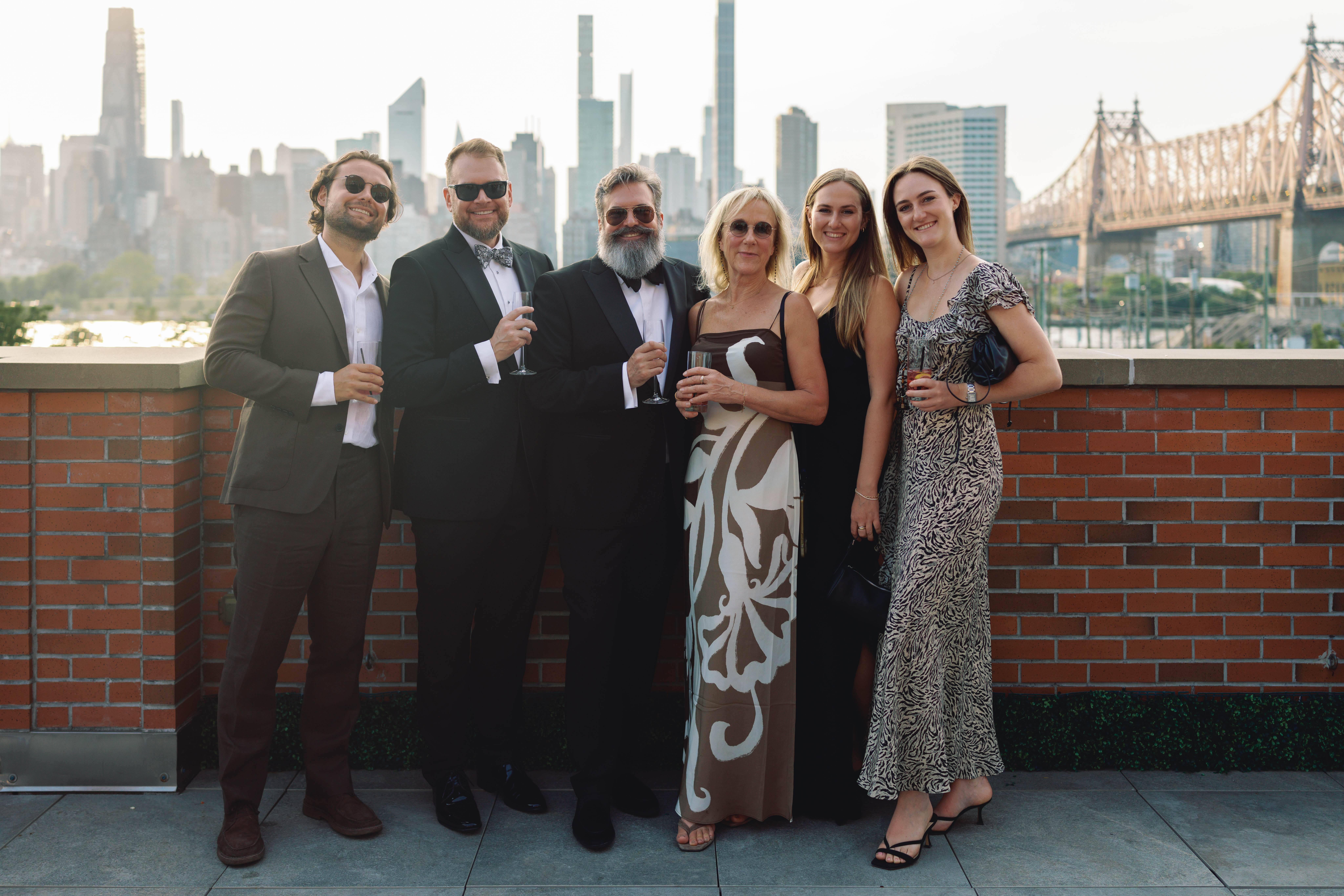 Guests in classic black tie attire with modern fashion elements