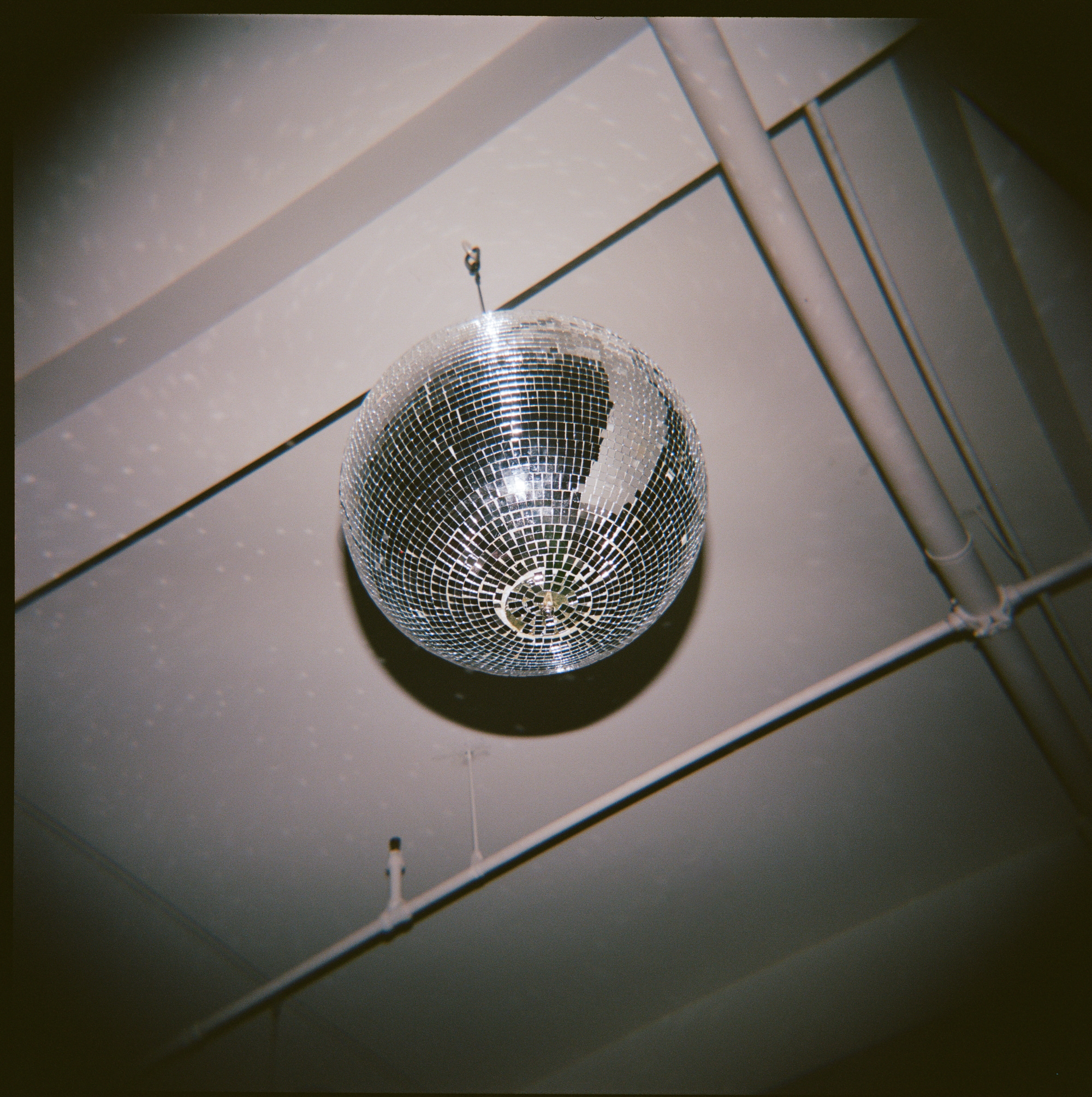 Checkered dance floor with disco ball overhead