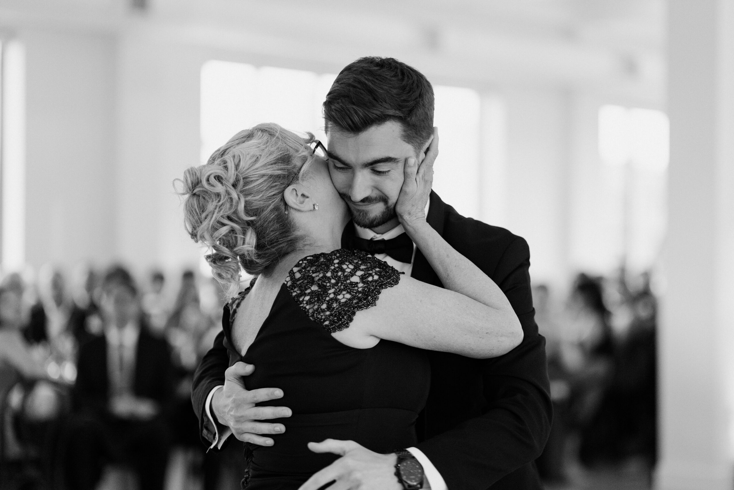 mother and son in classic black tie attire with modern fashion elements
