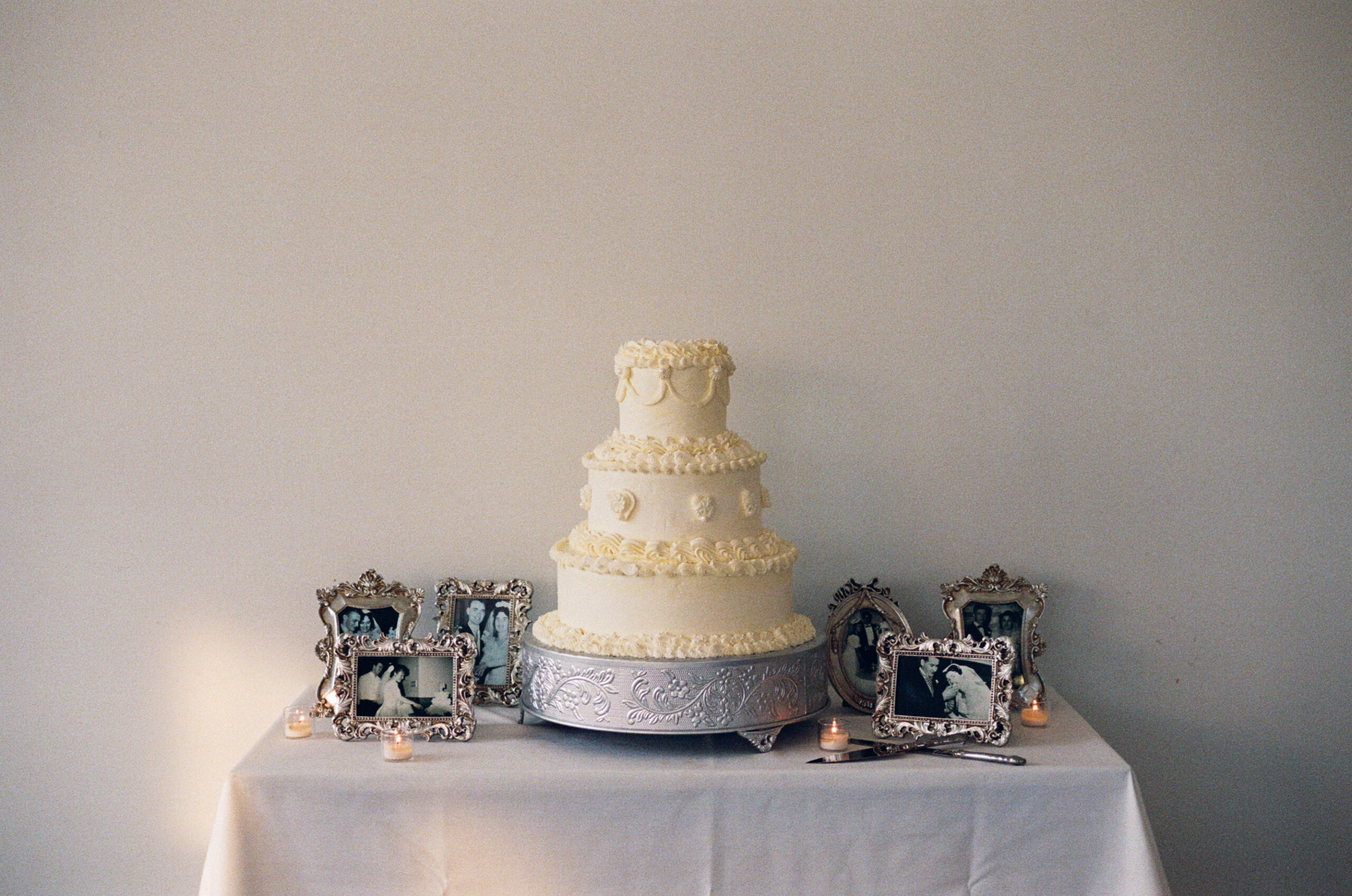 Silver frames featuring family wedding cake cutting photos from past generations
