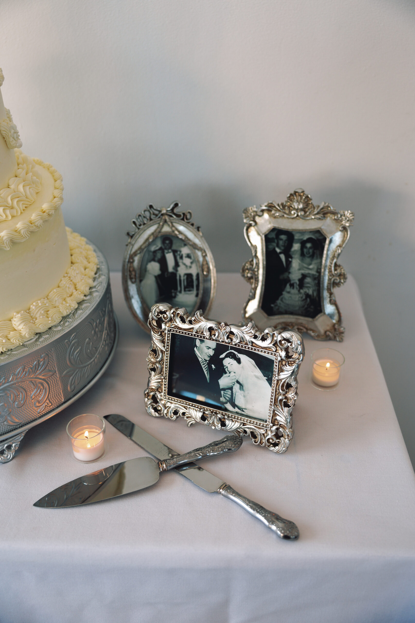 Silver frames featuring family wedding cake cutting photos from past generations