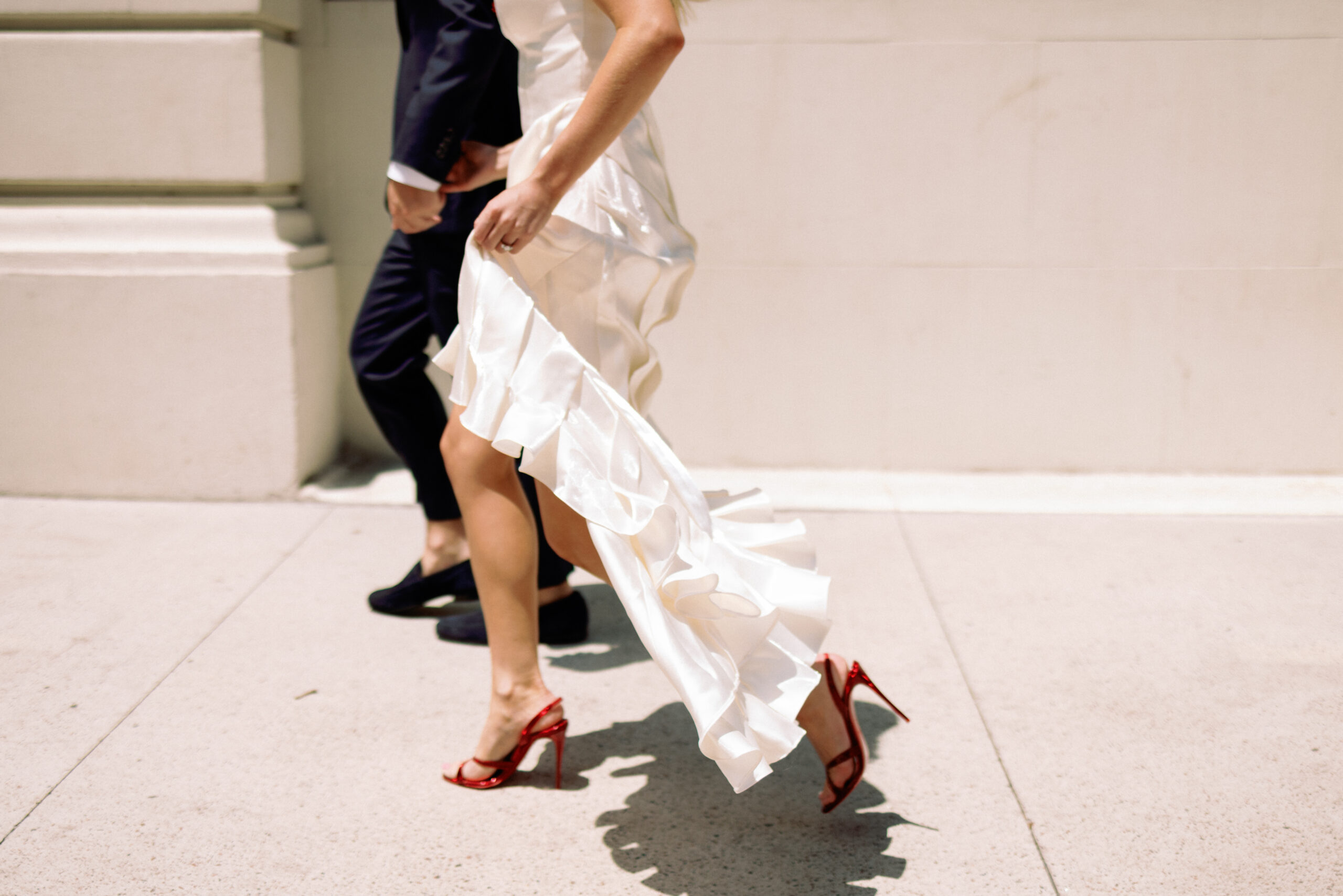 Couple walking through Manhattan streets in candid engagement moment